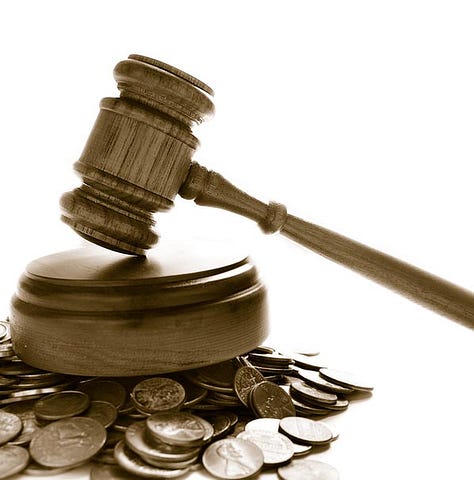 lawsuit gavel on coins