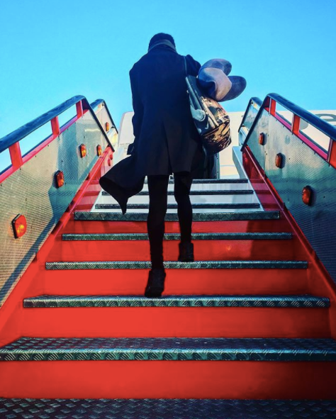 girl getting inside an airplane