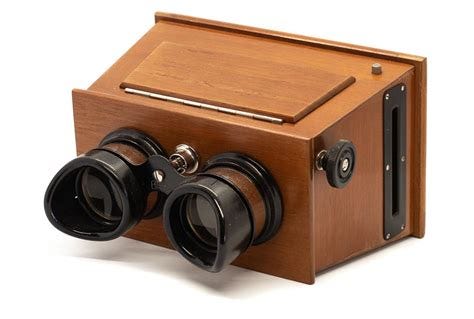 A stereoscope, which looks like a pair of binoculars with a wooden box on the end.