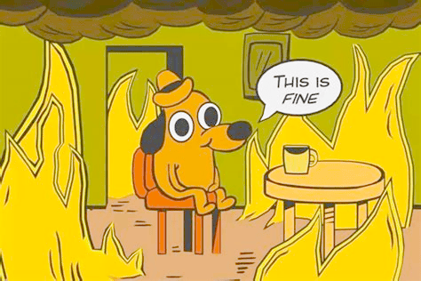 Cartoon dog sits calmly in a burning room saying “This is fine,” used to show how crisis gets normalised.