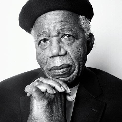 A black and white portrait of Chinua Achebe
