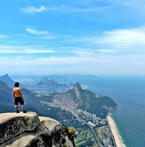 I stand before the best view ever at Pedra da Gávea in Rio de Janeiro, Brazil