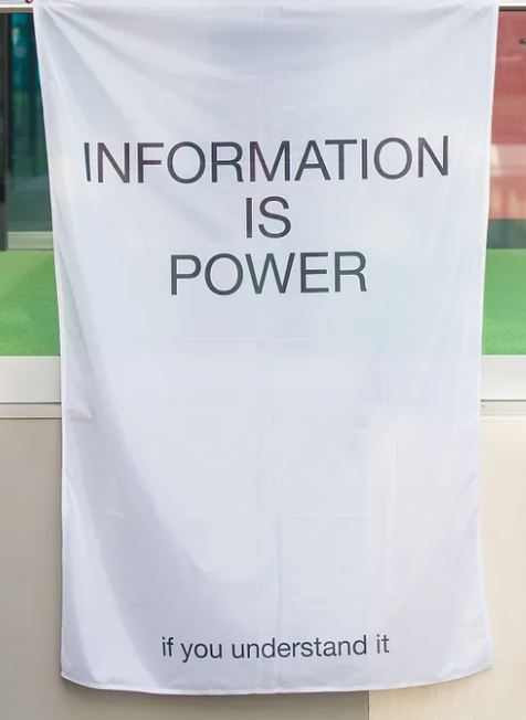 a banner saying “information is power — if you understand it”