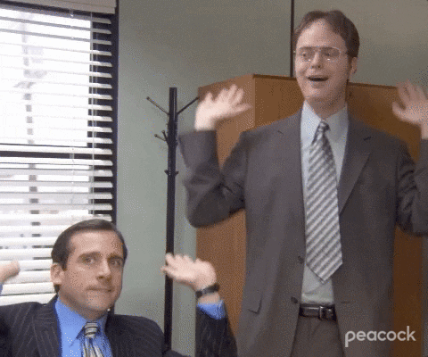 A GIF of two “Office” characters celebrating.