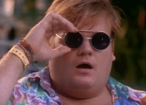 a gif of a man shocked by something lifting his sunglasses up from his face