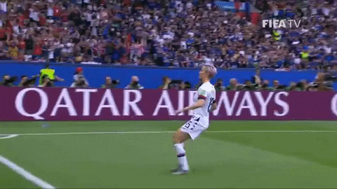 Megan Rapinoe celebrating with her hands extended