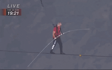 A man walking on a tightrope.