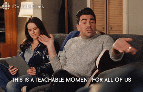 A scene from Schitt’s Creek where David (Dan Levy) is sitting on a couch and saying, “This is a teachable moment for all of us.”