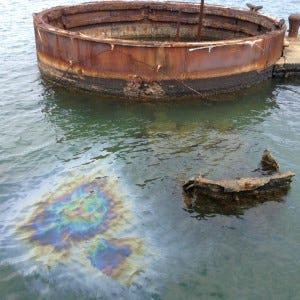 The gun turret and leaking oil from the sunken Arizona