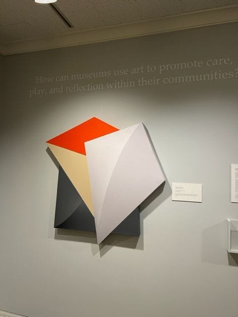 A three-dimensional canvas that features a lavendar kite-shaped figure in the forefront. There are three-dimensional shapes behind the kite.