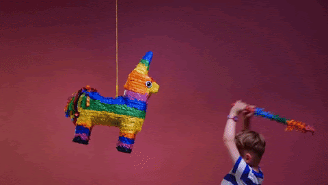 boy smashing piñata