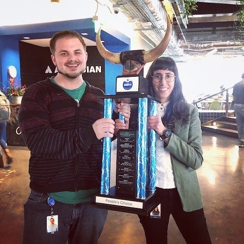Zak and I holding thetrophy from our Hackathon win.
