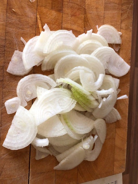 Slice your half onions finely — you can then break them up while frying.
