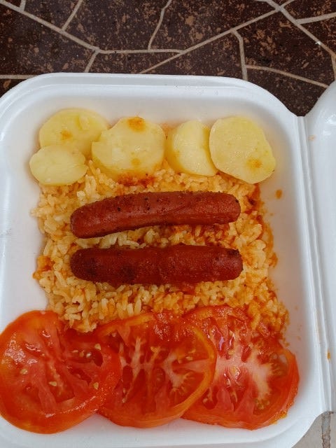 arroz amarillo (yellow rice), perritos (hot dogs) and ensalada (salad)