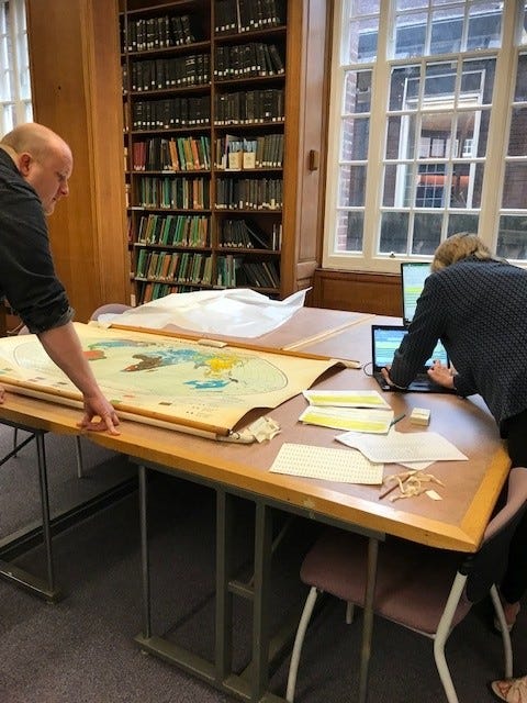 Two students looking at large map in special collections map room
