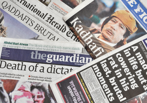 This photo displays international newspapers reporting the death of Muammar Gaddafi in October 2011.
