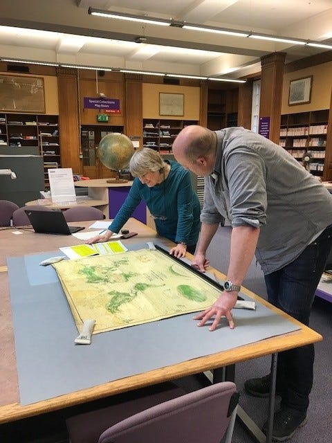 Students looking at map showing vegetation of the world