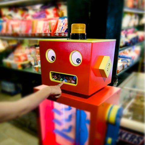 A photo of a funny-looking robot-candy machine. © Creoman 2024