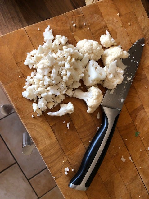 Chop the flowery bits off five florets of cauliflower so they resemble grains of rice.