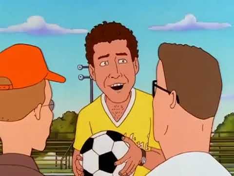 Will Ferrell as Coach Lucas holding a soccer ball and talking to Hank and Dale in King of the Hill
