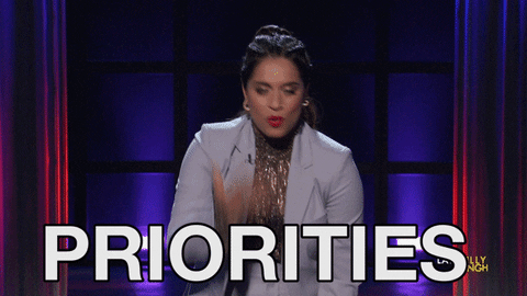 a gif of a woman pretending to juggle, with text that reads priorities