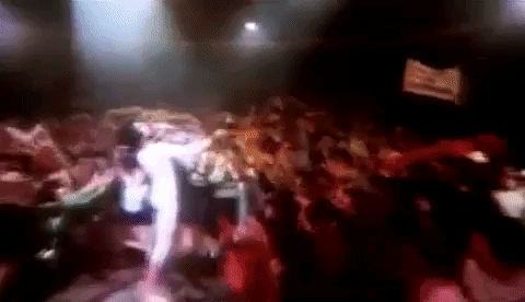 Freddie Mercury performing with an adoring audience