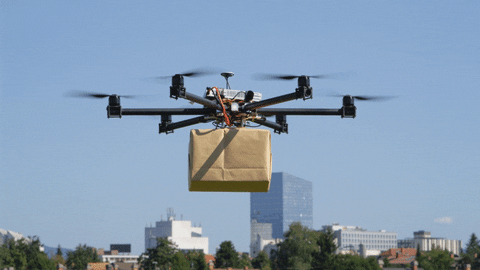 Flying drone carrying a package for delivery