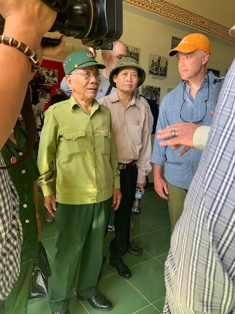 A Vietnamese war veteran talks to U.S. veterans inside a small museum