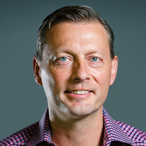 Color photo of Eric Wrobel, a White man with blue eyes and plaid shirt, Head of Product at Blend.