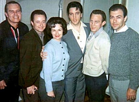 Elvis stands with his arms around the Jordanaires and Millie Kirkham
