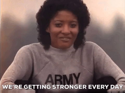 Woman in a gray sweater that says “Army” on the front above a caption reading, “We’re getting stronger every day.”