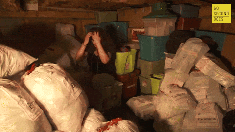 Overwhelmed woman in her garage frantic about the overabundance of stuff