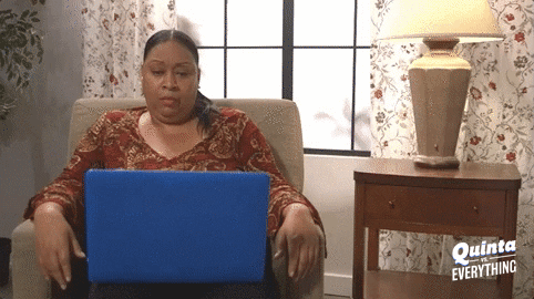 A GIF of a woman looking confused at a laptop.