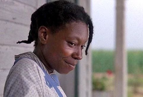 An image of Celie from the movie adaption of Alice Walker’s novel The Color Purple, smiling softly and gazing to her right.