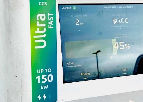 Photo of a charging station screen showing 107 kW charging rate