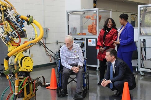 Secretary Buttigieg looks at Robotic Training Equipment at Lawson State Community College