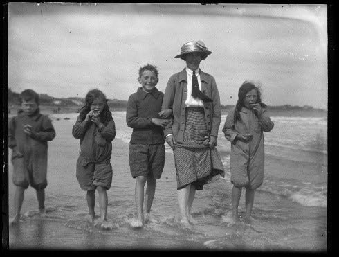 Black and white image of a family at the seaside c1900s