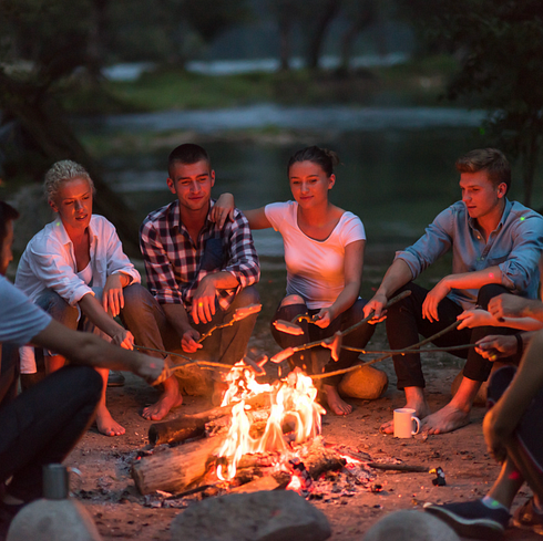 People sat around a campfire