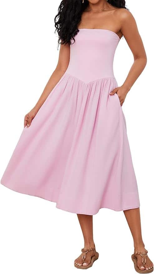 Model wearing a baby pink, midi length sundress.