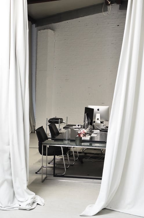 Photo of computers in an office shrouded with curtains