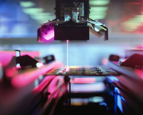 Futuristic blurred image of a laser being used in a machine.