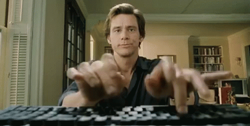 Jim Carrey in Bruce Almighty typing furiously at his computer