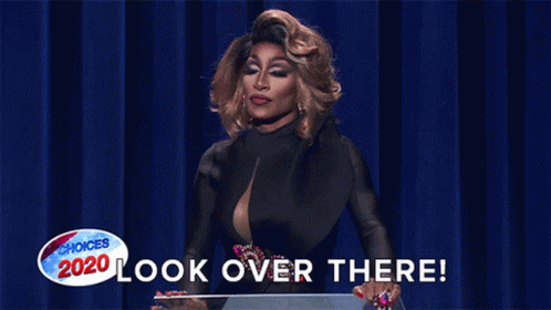 GIF of Jaida Essence Hall, winner of Rupaul’s Drag Race, saying “Look over there!” as she points off into the distance