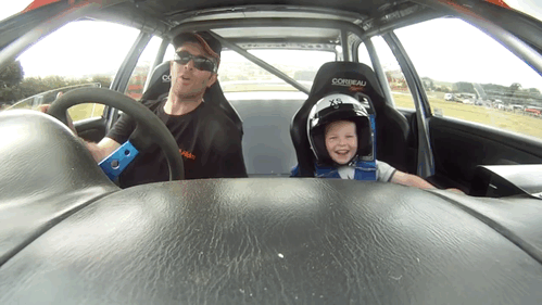 Happy child in the race car