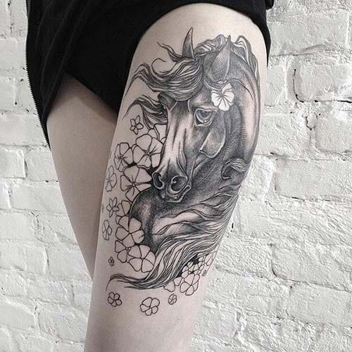 woman thigh horse tattoo