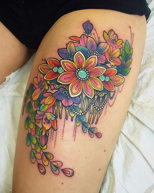 woman thigh colorful flower tattoo