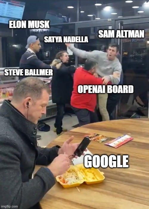 Meme featuring a photo of a man at a fast-food restaurant, engrossed in his phone, with a plate of food in front of him, labeled ‘GOOGLE.’ In the background, four people labeled ‘ELON MUSK,’ ‘SATYA NADELLA,’ ‘SAM ALTMAN,’ and ‘STEVE BALLMER’ are edited into an image of a physical altercation, representing ‘OPENAI BOARD.’ The meme humorously depicts Google as uninvolved and indifferent to a chaotic situation involving the leadership of OpenAI.