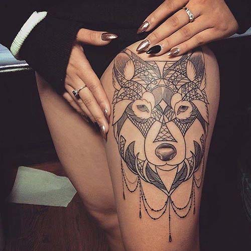 woman thigh wolf tattoo