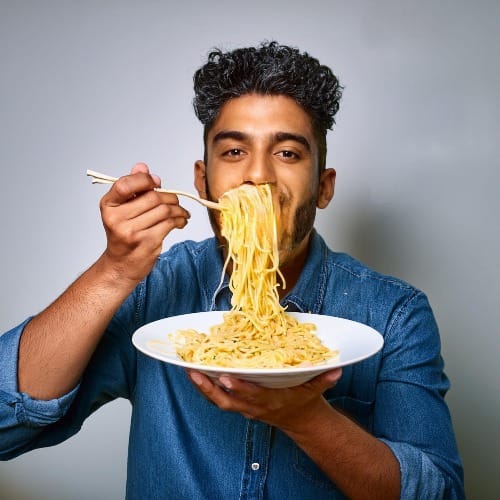 An AI generated image of a man eating spaghetti … strangely.