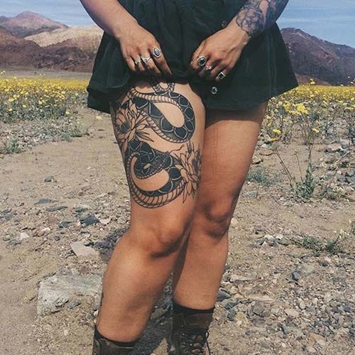 woman thigh snake tattoo